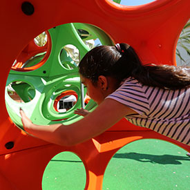 Girl climbing through the PlayCubes climbing frame